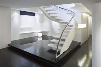 Modern white staircase with glass banister