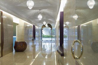 View down long modern marble hallway