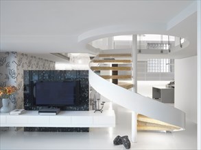 Modern winding staircase and television