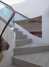 View midway up modern staircase with glass railing