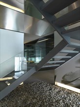 View from below modern glass and concrete staircase