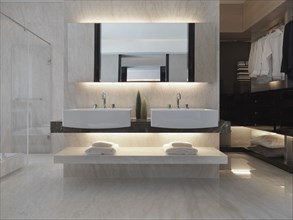 Master bathroom with double sinks and closet space