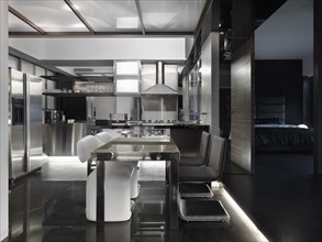Modern black and white kitchen and dining area