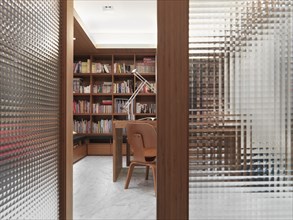 Open translucent doors leading to modern home office