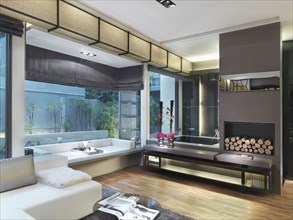 Spacious modern bathroom with sitting area and glass shower