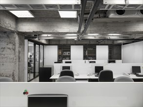 Modern industrial office with rows of computers
