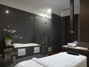 Spa room with hot tub and massage table