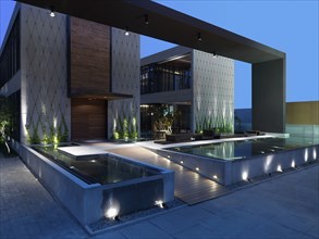 Modern building at dusk with infinity pools