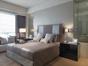 Elegant bed in modern bedroom