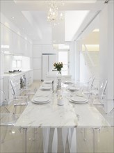View down marble dining table into kitchen