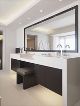 Vanity between sinks in modern bathroom