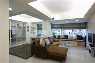Interior of a modern living room with brown sectional sofa