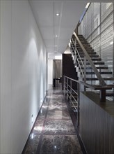 Hallway along staircase in modern home
