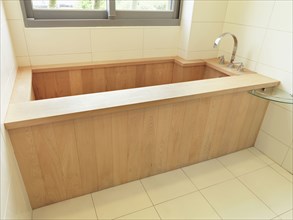 Wooden bathtub in modern bathroom