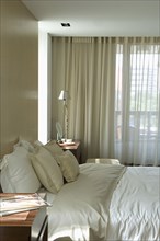 Light colored pillows and comforter on bed