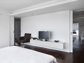 Modern white bedroom with hardwood floors