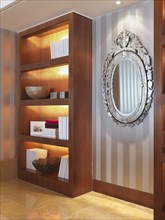 Bookcase and striped wallpaper in modern home