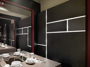 Black wall with built in lights in asian dining room