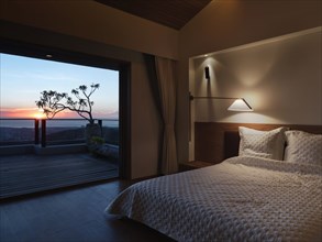 Modern bedroom at sunset