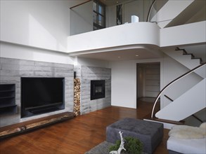 Entertainment center and Staircase to upstairs in large modern home
