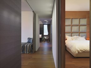 Hardwood hallway between bedroom and living room in modern home