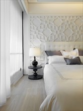 Collection of pillows on elegant white bed