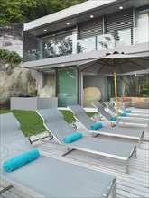 Row of lounge chairs outside modern home