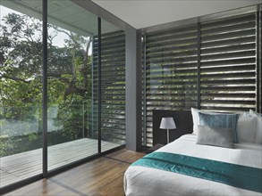 Floor to ceiling windows in modern bedroom