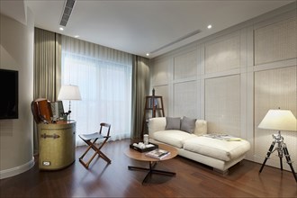 Small sofa in master bedroom of modern home