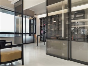 Pocket doors separating living from office in modern home