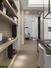 Hallway through modern home with bookcase