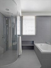 Large glass shower in modern gray bathroom