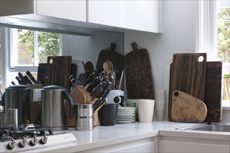 Cutting boards and knives on countertop in kitchen