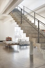 Concrete staircase to second level in loft style home