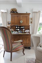 Striped armchair at wooden desk in traditional living room