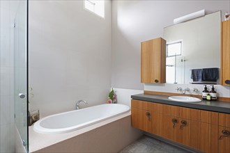 Bathtub and cabinets in contemporary bathroom