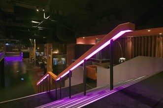Staircase leading down to lounge area in nightclub