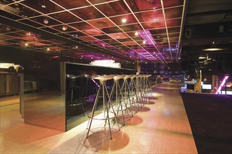 Bar counter with stools in modern nightclub