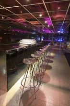 Bar counter with stools in modern nightclub