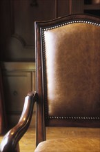 Brown leather and wood armchair