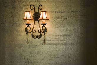 Wrought Iron Lamp on Gold Textured Wall