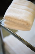 Folded Towel on Top of Glass Shelf