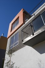 Exterior of Modern Home with Orange Wall and Balcony