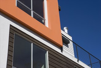 Exterior Detail of Orange Wall and Balcony