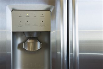 Detail of refrigerator door with water and ice dispenser