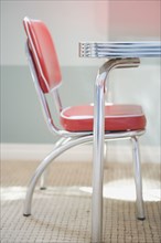 Detail of a red and chrome Retro Style children's table with chair