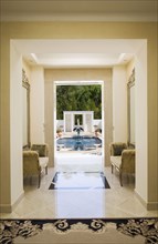 Interior of a marble hallway leading to a pool