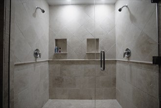 Detail of dual stone showers with glass door