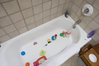 Detail of bathtub filled with baby toys