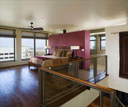 Image of contemporary master bedroom with city view.